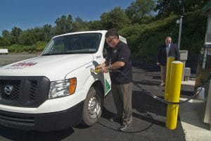 Man pumping natural gas into vehicle