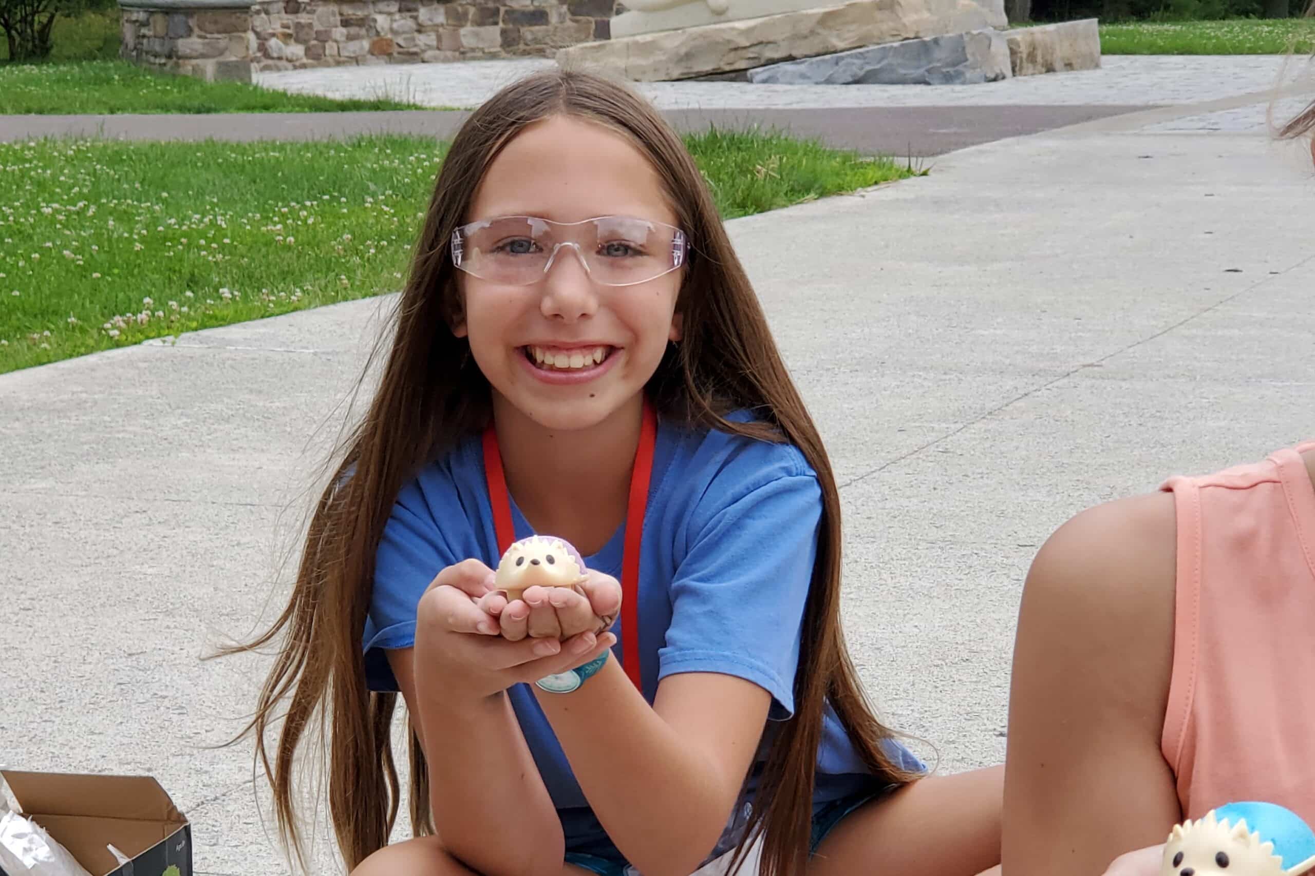 Student at STEM Camp holds a crystal hedgehog science experiment