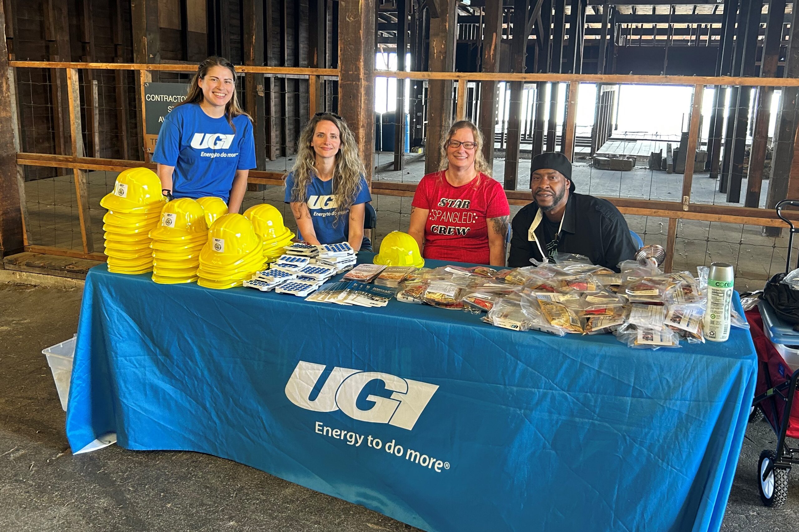 UGI employees at booth with safety hats and other merch for Customer Assistance Programs