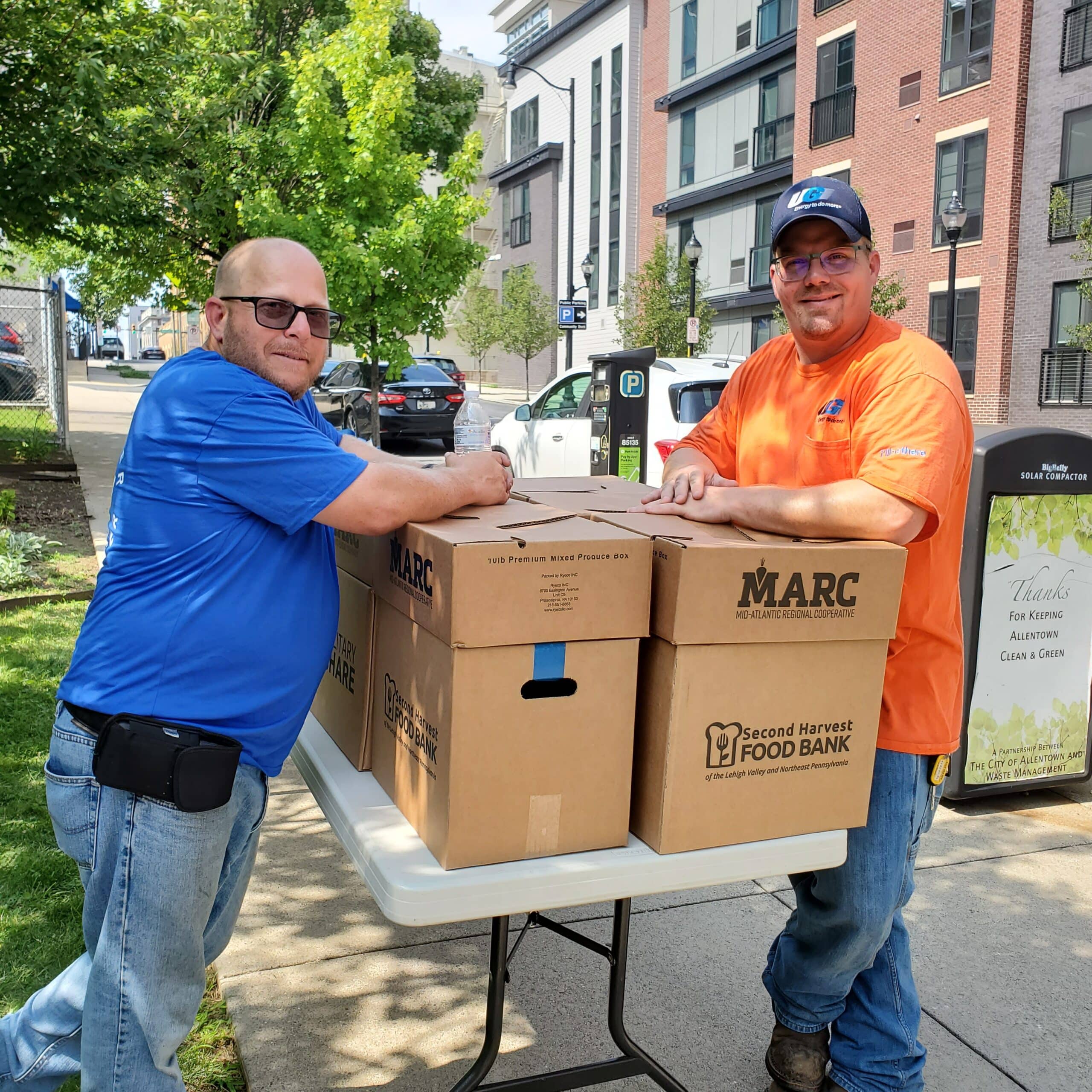 UGI employees stand next to food boxes from Second Harvest.