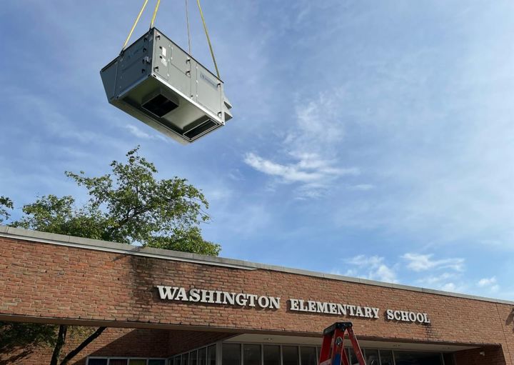 HVAC system being lifted to roof of Washington Elementary School in Allentown.