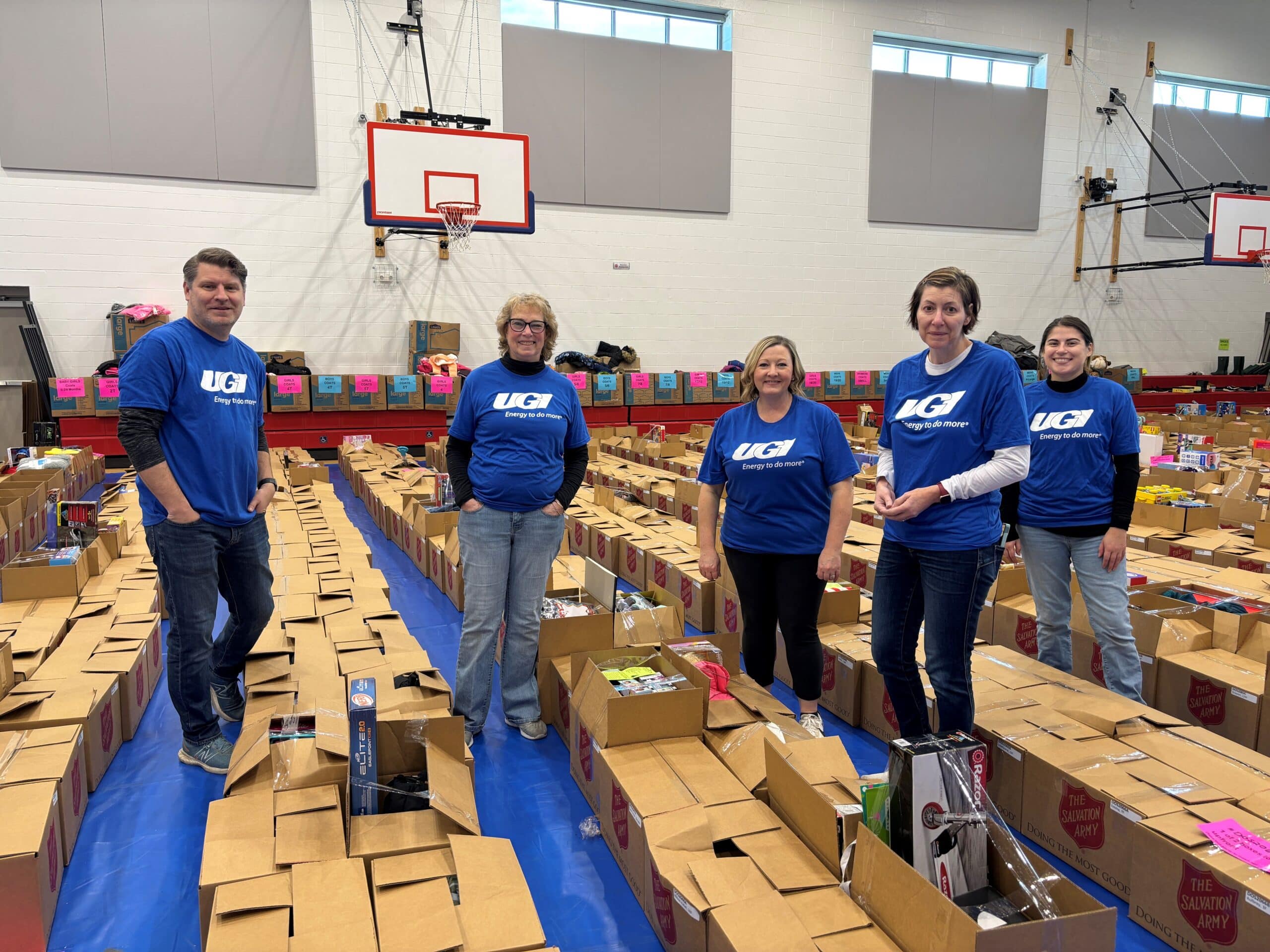 UGI employees stand with Angel Tree boxes.