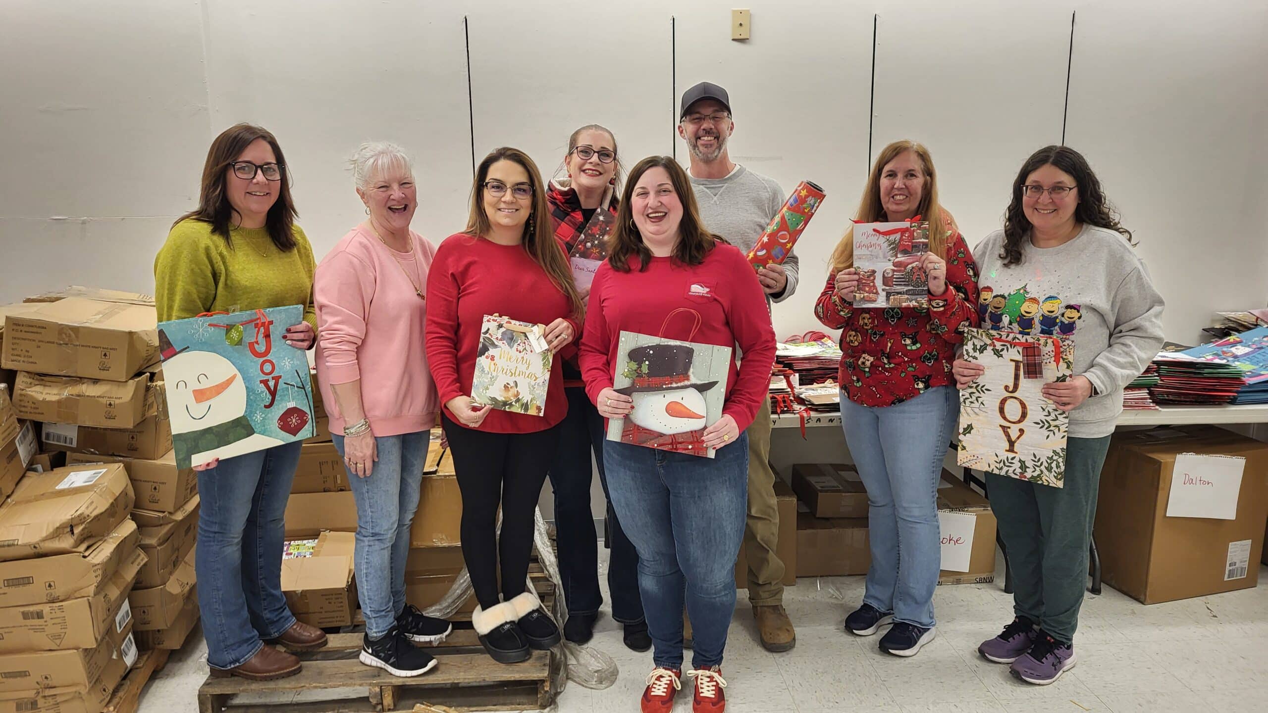 UGI employees hold presents they wrapped for local children.