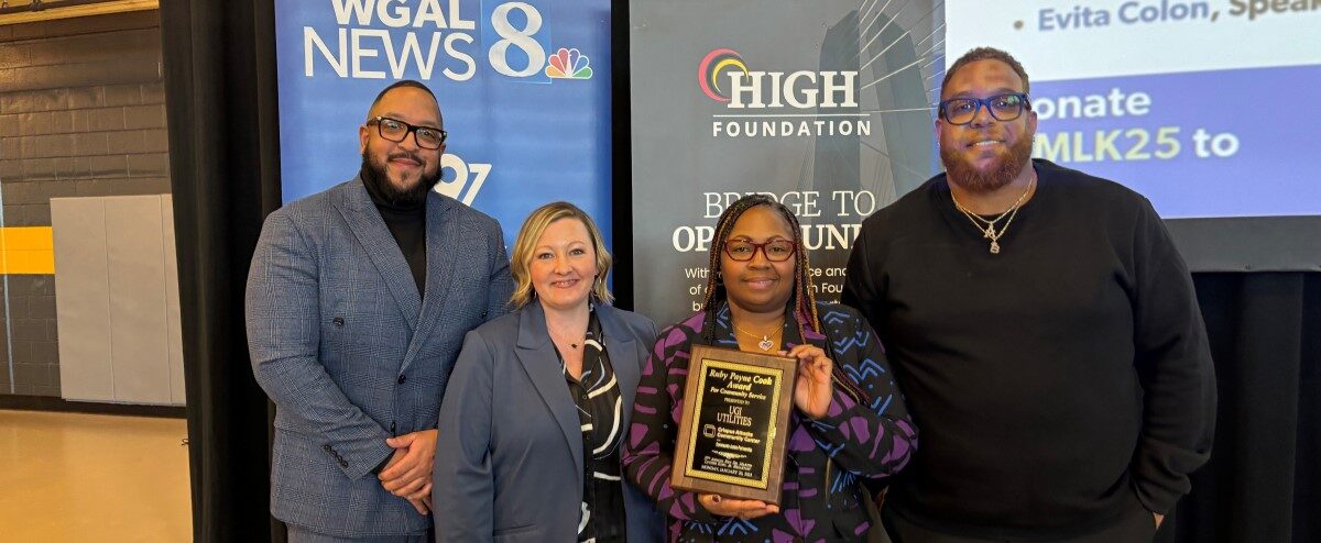 UGI employees holding the award presented to them by Crispus Attucks Community Center.