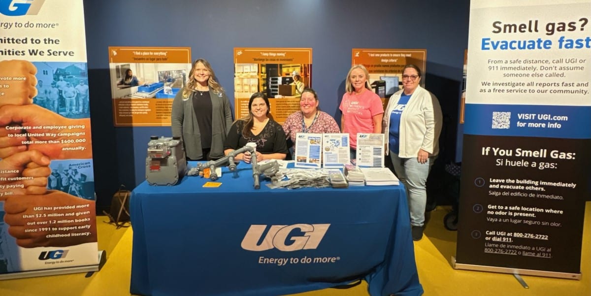 Employees at a UGI table at the Da Vinci Science Center's Women in Science and Engineering event.