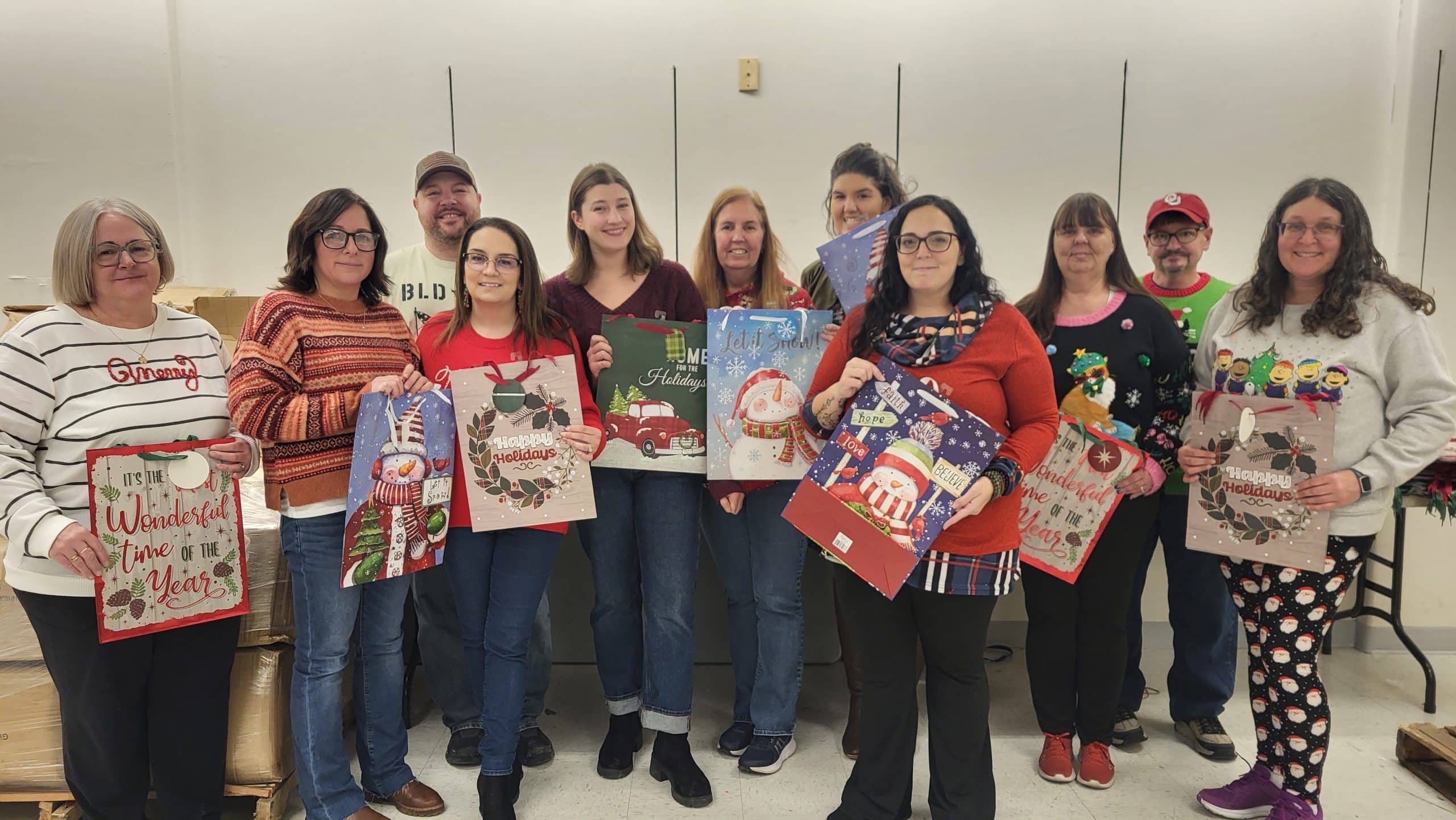 UGI employees stand with holiday gifts.
