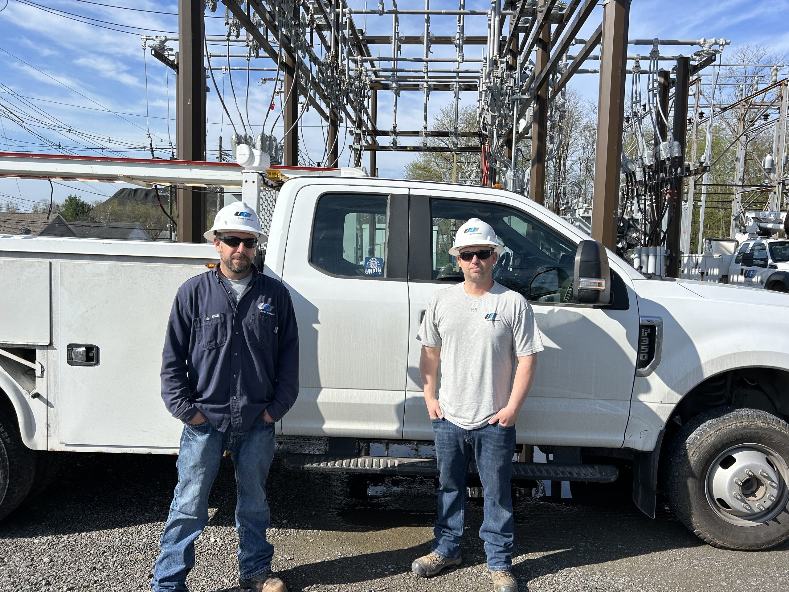 Two UGI employees stand outside of truck.