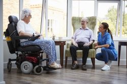 Residents Talking With Nurse In Retirement Home